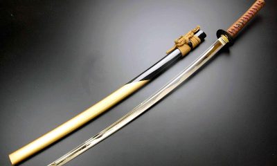 1. A Japanese katana with a wooden handle and a gold blade.