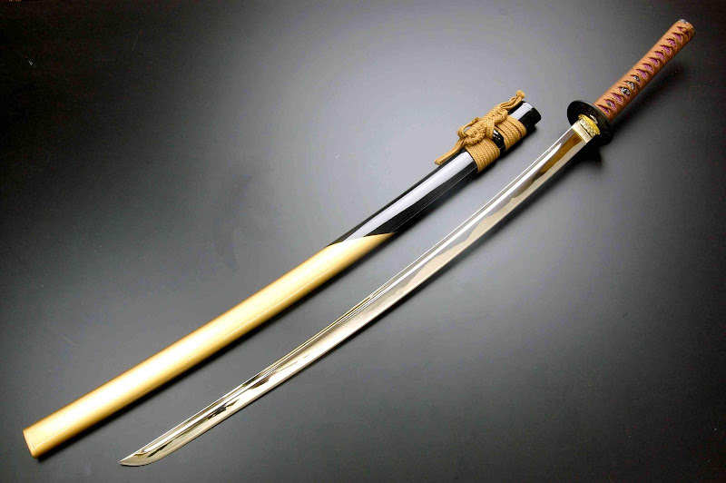 1. A Japanese katana with a wooden handle and a gold blade.